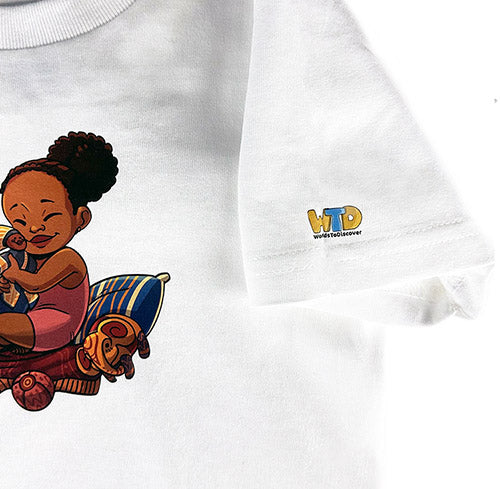 White short sleeve t-shirt for toddlers featuring Baby Princess sitting with her magical doll and toys. A playful design inspired by the Baby Princess Adventures picture book.